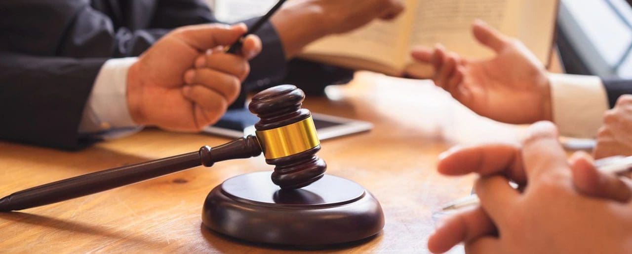 A judge's gavel on a desk during a legal proceeding.