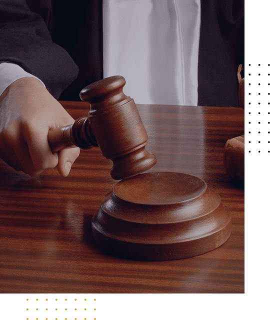 Judge striking a gavel in a courtroom.